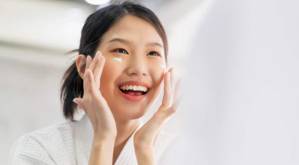 A Korean woman using skincare products